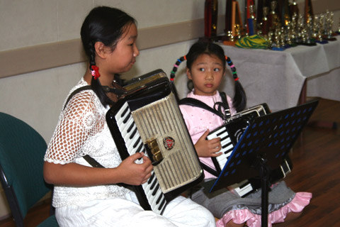 Jessica and Marina Jin playing a duet.