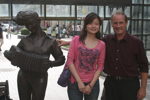 Linda Lee (translator) and Raymond Bodell with accordion statue