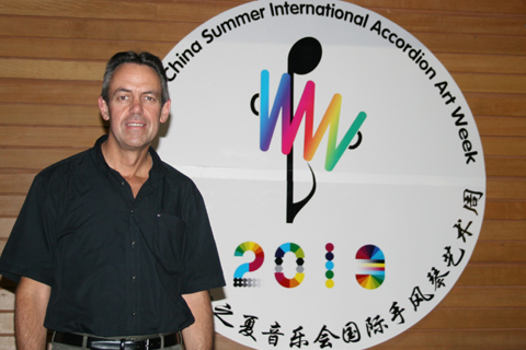 Kevin Friedrich with festival logo banner